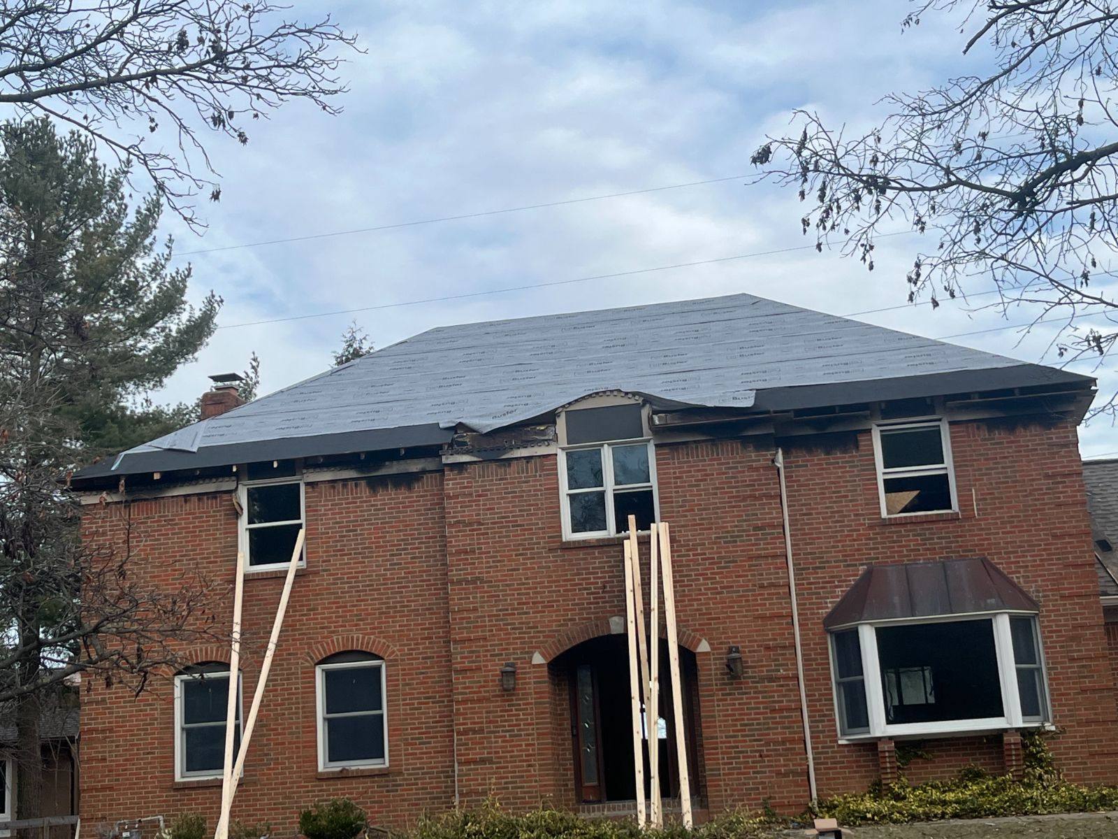 Re-roof in progress on a brick home by Resolute Construction and Remodel